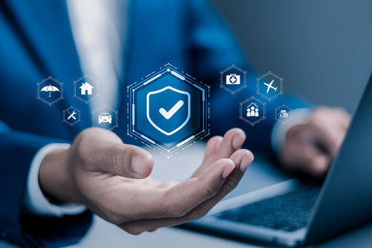Insurance and assurance concept, Businessman using laptop with insurance icons for medical, life, car, home, travel insurance.