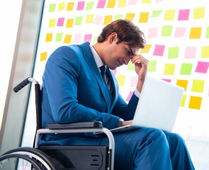 Young handsome man in wheelchair with many conflicting prioritie