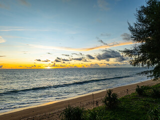 Aerial view of sky turns yellow to orange and red over the sea..The sun rays cast a warm glow on the landscape. The horizon is painted in hues of red and purple. The sky is ablaze with color