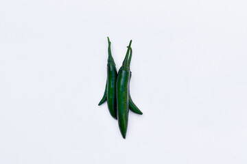 Green chili peppers on white background