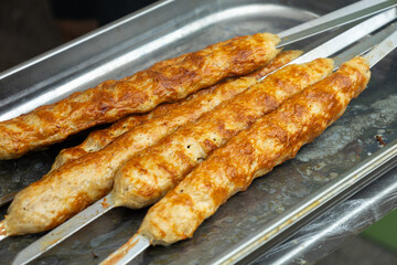Ready kebab close-up on a silver tray, street fast food