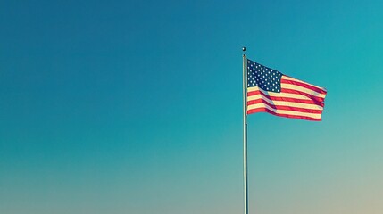 The American flag waving against a clear blue sky, symbolizing patriotism and freedom