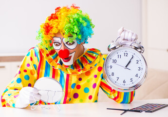 Male clown preparing for perfomance at home