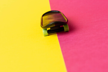 Miniature Skateboard on Colorful Yellow and Pink Background