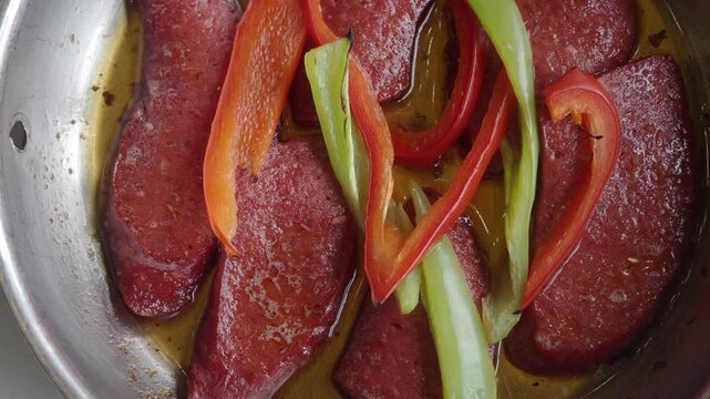 Turkish fried sausage sucuk in a pan