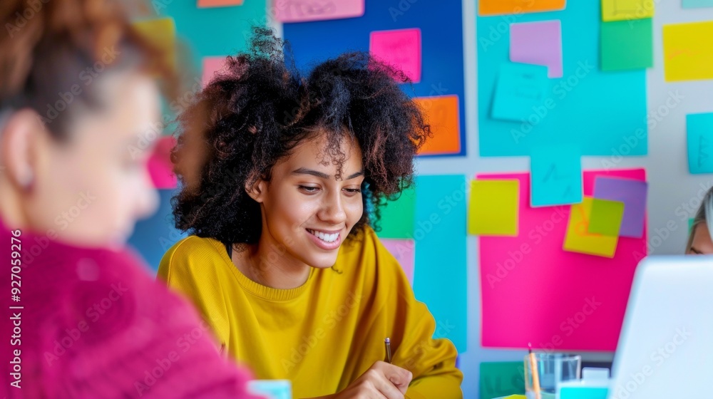 Aufkleber young diverse team of adults brainstorming with laptops and colorful post-it notes in a modern, well