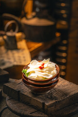 Tripe also called cow stomach, a common ingredient in Chinese hot pot, with text on blurred background in Chinese style indoors
