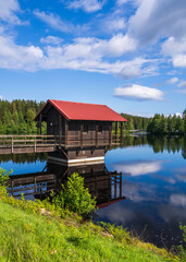 Obraz premium Small lake in woods. In the foreground rocks in water, trees. High quality photo. Fichtelsee, Bavaria, Germany