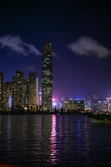 Fototapeta premium The night view of Hong Kong Island from the Kowloon. Hong Kong cityscape and seascape at night. Nature and city scene.