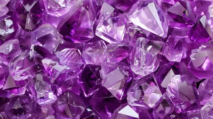 A close-up view of a cluster of purple amethyst crystals, each with a unique shape and sparkle.