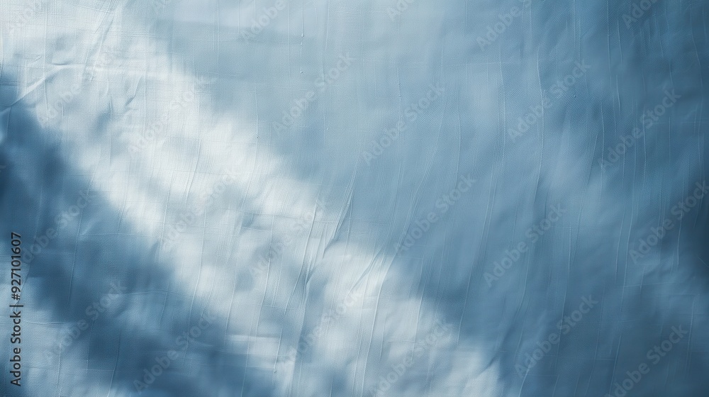Poster A close-up image of a blue fabric with white light patterns creating an abstract design. The fabric is wrinkled and creased, giving the surface a textured appearance.