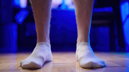 Flat feet forcing arch up exercise wearing white socks close-up