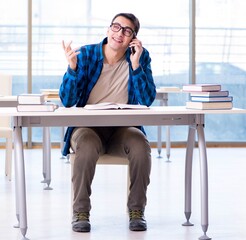 Student studying in the empty library with book preparing for ex