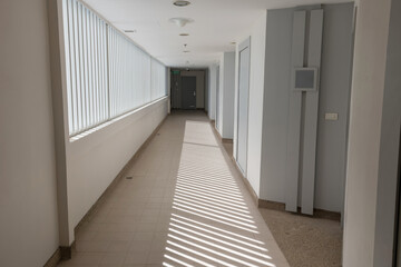 Obraz premium Hotel building corridor with light shade through window