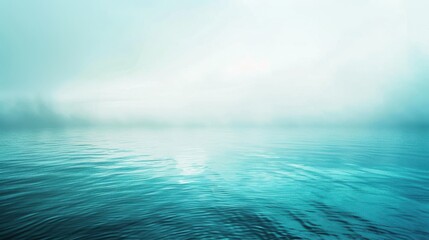 Obraz premium The image shows a tranquil lake scene with fog rolling in over the water. The sky is a soft blue, with wispy clouds and a hint of sunshine breaking through. The water is calm, with gentle ripples caus