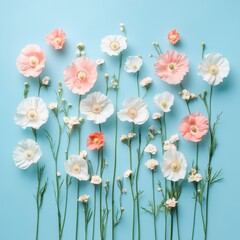 Pastel flower arrangement against a soft blue background