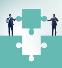 Businessman in teamwork concept with jigsaw puzzle