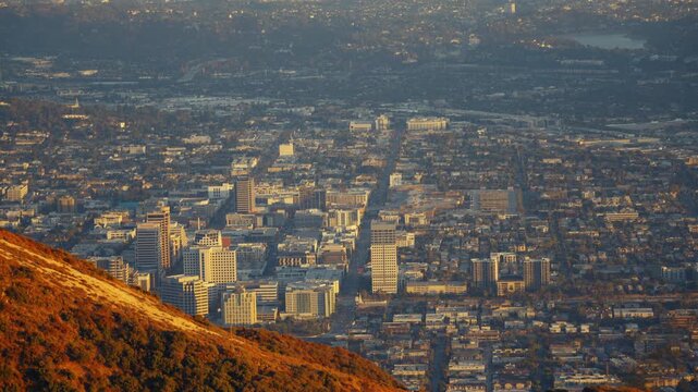 A warm, sunny mountain in the foreground with Glendale city buildings in a top view background. The scene captures the harmony between the natural landscape and the urban environment.