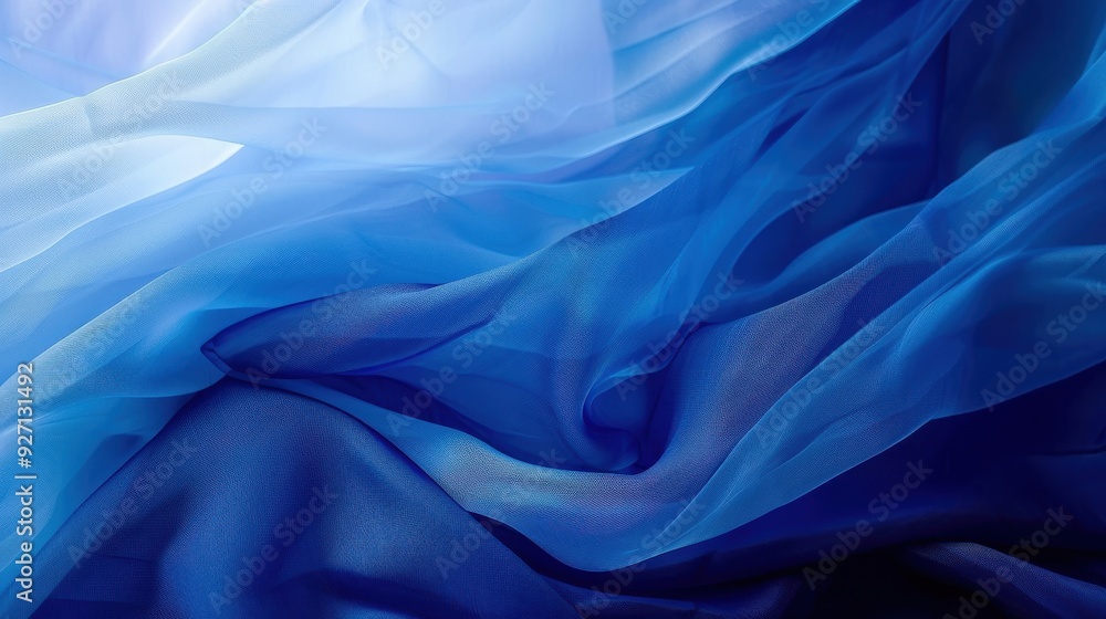 Poster a close-up photograph of a piece of blue sheer fabric that is draped and flowing, catching the sunli
