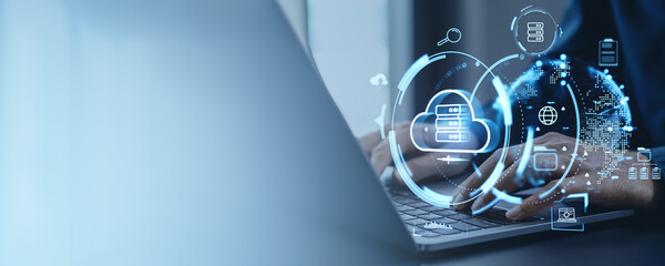 Digital cloud computing concept with hands on laptop keyboard in office.