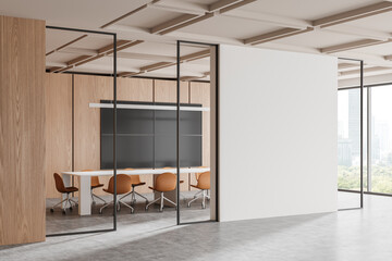 Glass meeting room interior with board and chairs, tv displays and mock up wall