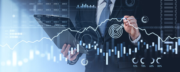 Man pen touch forex diagrams and stock market data with dashboard