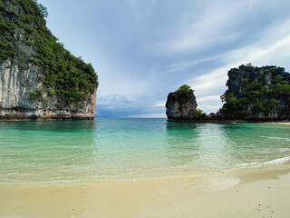 The natural landscape of Hong Island Krabi Province in Thailand, where tourists from all over the world come to visit nature, Asia, summer vacation trips. Tourists at the beach under a cloudy sky