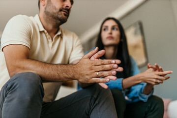 Couple sitting on the couch trying to solve the problems at home in the living room