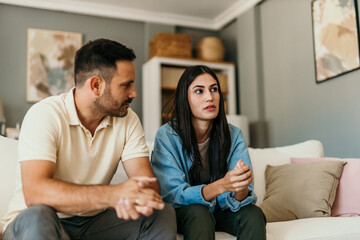 Fight, divorce, and depression with a couple on the sofa for conflict, therapy, and mental health...