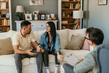 Fototapeta premium Shot of an upset young couple sitting together during a consultation with a psychologist