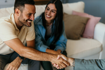 Happy man and woman clients handshake close deal with a legal adviser