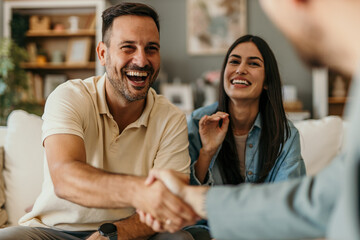 The young happy couple and an agent in a new property, or a professional psychologist advising...