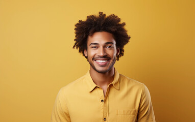 Fototapeta premium A man with a big smile on his face is wearing a yellow shirt. He is posing for a picture and he is happy