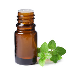 Essential oil in bottle and oregano leaves isolated on white