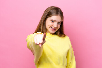 Teenager Russian girl isolated on pink background pointing front with happy expression