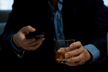 Businessmen discussing work and drinking Vikis in a dark room, close-up photo