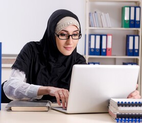 Female employee in hijab working in the office