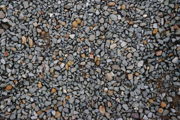 Dirty gravels grunge concrete wall. Stone and pebble rock texture on surface wall background