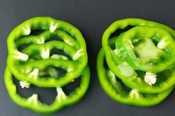 Slices of peppers are on a . Food fruit nature concept. A plate with slices of greens, green peppers, and . A plate with slices of greens and pepper lifestyle on the.