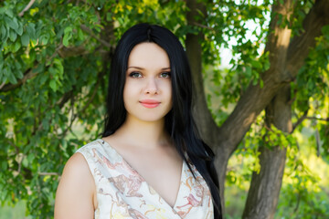 Fototapeta premium A girl a dress nature with trees. flower concept. a girl in green dresses is surrounded by trees in nature. a girl in green and white dress in lifestyle nature.