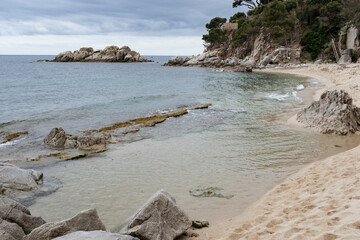 Beautiful sandy beach in quiet waters of Mediterranean Sea in Costa Brava