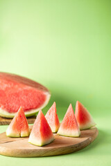 Cut watermelon in the background and watermelon triangles in the foreground