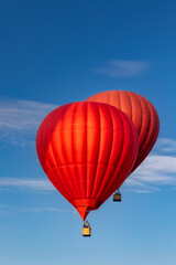 Vivid colorful hot air balloons close up against clear blue sky on sunny day
