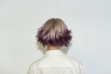 Stylish women's hairstyle for short multi-colored dyed hair on a white background. An...