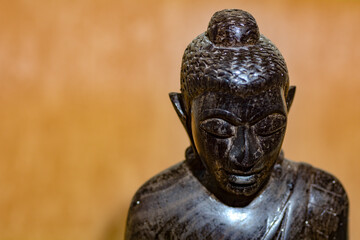 Fototapeta premium Face of a wooden Buddha figure