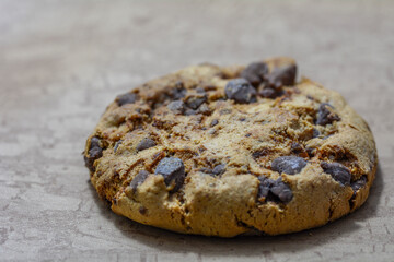 Close up of a ahocolate cookie  isolated on brown