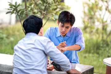 Fototapeta premium A guy scolds and blames someone for being late. Men getting scolded for being late.