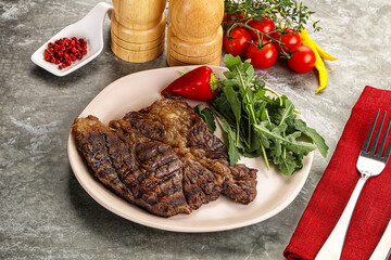 Grilled chuck roll steak with arugula