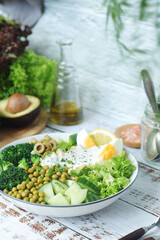 A bowl with a salad made of green vegetables