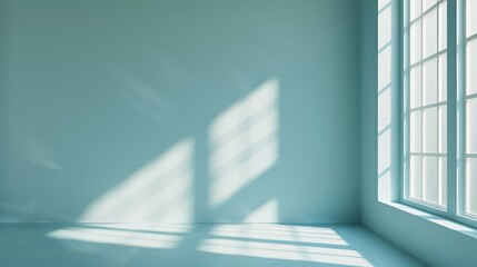 Obraz premium Sunlight streams through a large window, casting geometric shadows and bathing an empty, minimalist room in a soft, serene light.